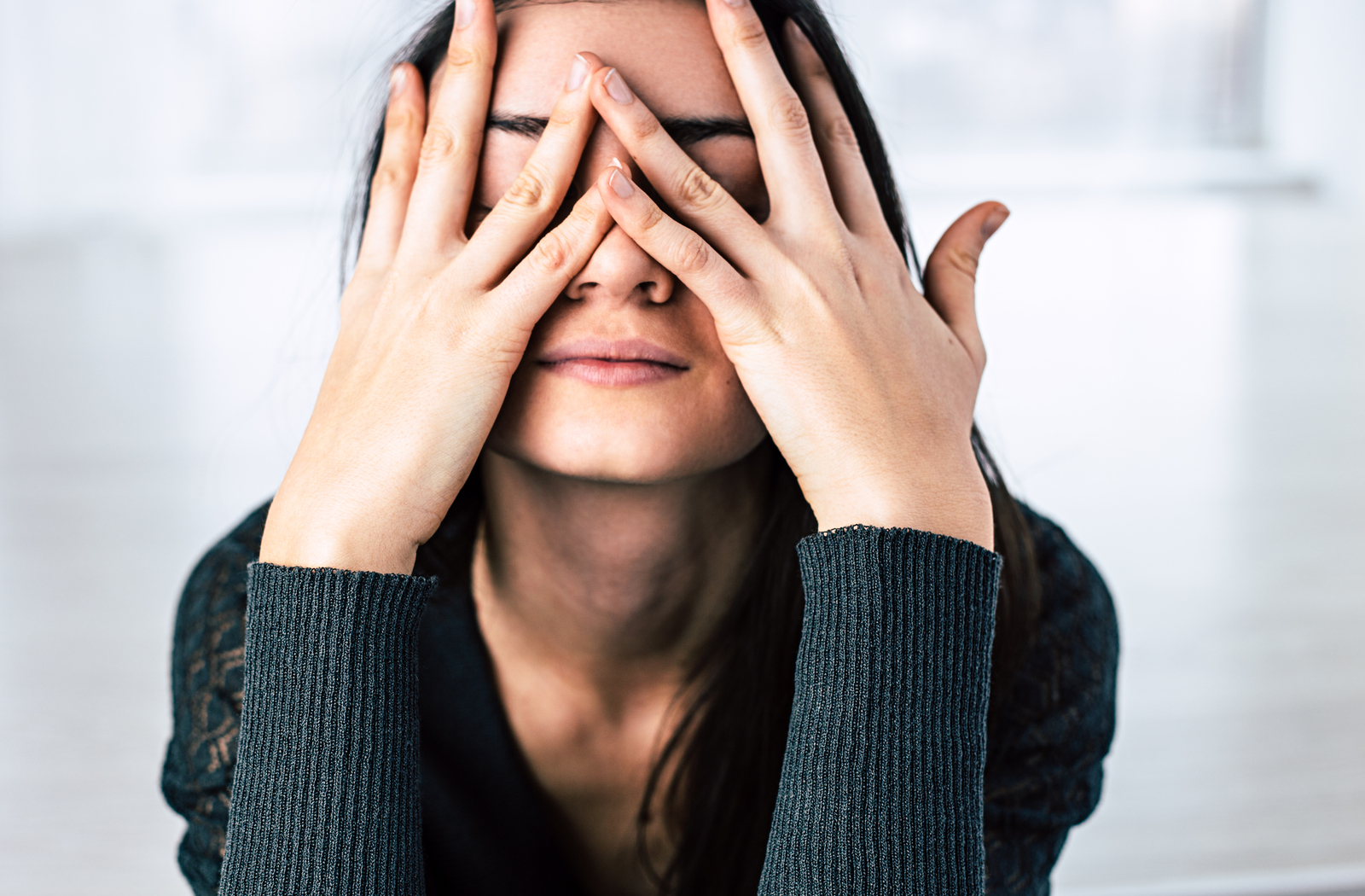 Stressed women touching face and experiencing dry eyes as result
